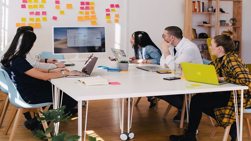 A team in an office discussing email capture during a meeting