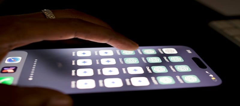 A person holds a phone displaying a vibrant screen, symbolizing AI's role in enhancing customer experiences